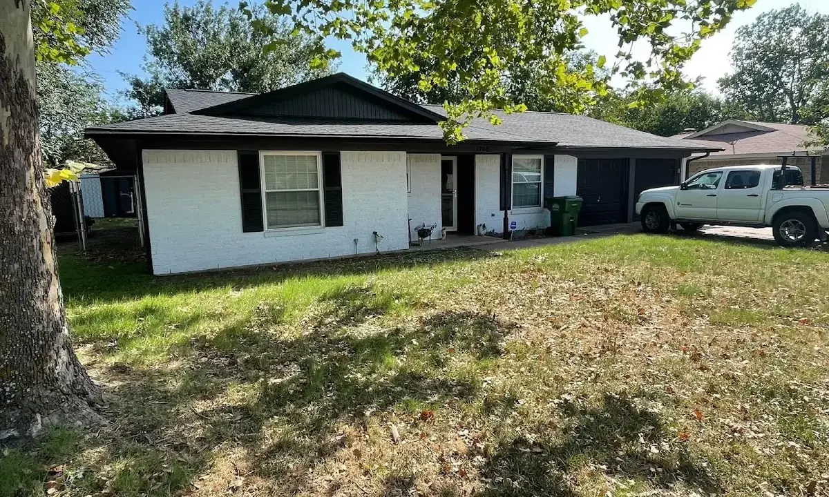 Professional roofing crew working on a residential roof in Tenafly
